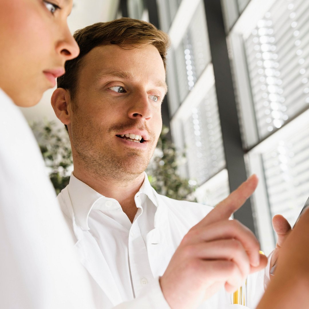 Scientist explaining software to co-worker